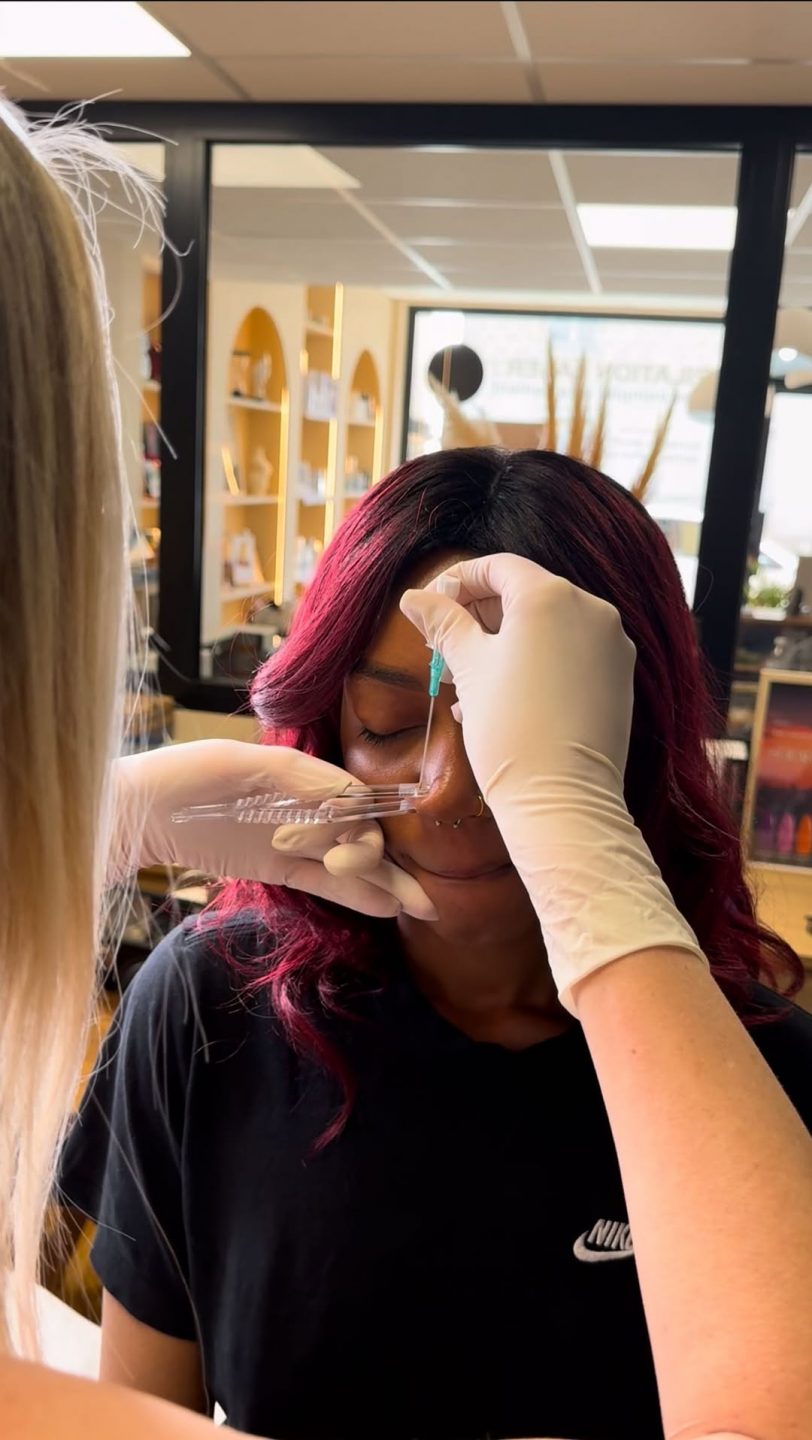 une femme en train de se faire percer le nez lors d'une formation piercing